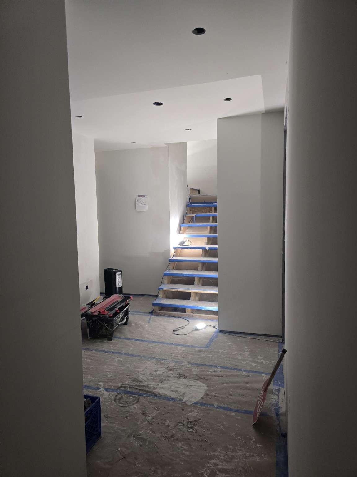 Drywall walls and ceiling near a stairwell